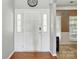 Welcoming entryway features a classic white door with sidelights and beautiful hardwood floors at 2324 Oakdale Creek Ln, Charlotte, NC 28216