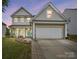 Charming two-story home with stone accents and a two-car garage under a picturesque twilight sky at 2324 Oakdale Creek Ln, Charlotte, NC 28216