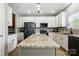Spacious kitchen featuring an oversized island with granite countertop, stainless steel appliances, and modern lighting at 2324 Oakdale Creek Ln, Charlotte, NC 28216