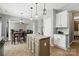 Open-concept kitchen with an island, granite counters, and seamless flow to the dining and living areas at 2324 Oakdale Creek Ln, Charlotte, NC 28216
