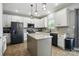 Modern kitchen featuring white cabinets, granite countertops, stainless steel appliances, and a center island at 2324 Oakdale Creek Ln, Charlotte, NC 28216