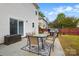 Patio with outdoor seating and a grill, great for entertaining in the fenced backyard at 2324 Oakdale Creek Ln, Charlotte, NC 28216