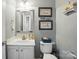 Cozy powder room featuring neutral colors, framed nautical art, and ample lighting at 2324 Oakdale Creek Ln, Charlotte, NC 28216