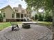 The backyard has a stone patio, fire pit, and lush greenery, perfect for entertaining at 2406 Tarleton Twins Ter, Charlotte, NC 28270