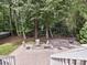 Backyard features a stone patio with outdoor furniture and a cozy fire pit at 2406 Tarleton Twins Ter, Charlotte, NC 28270