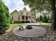 Private backyard has a stone patio, fire pit, and mature trees for outdoor living at 2406 Tarleton Twins Ter, Charlotte, NC 28270