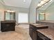 Bathroom featuring dual vanities, soaking tub, and travertine tile at 2406 Tarleton Twins Ter, Charlotte, NC 28270