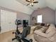 Spacious bonus room offers a comfy couch and exercise equipment, perfect for flexible living at 2406 Tarleton Twins Ter, Charlotte, NC 28270