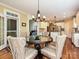 Open dining room with hardwood floors, chandelier, and views into the kitchen at 2406 Tarleton Twins Ter, Charlotte, NC 28270