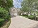 Inviting two-story home with a long driveway, attached two-car garage and well-manicured landscaping at 2406 Tarleton Twins Ter, Charlotte, NC 28270