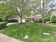 Charming two-story home with lush green lawn, mature trees, and welcoming front porch at 2406 Tarleton Twins Ter, Charlotte, NC 28270