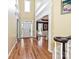 Bright foyer featuring hardwood floors, stairs, high ceilings, and an open view to the dining room at 2406 Tarleton Twins Ter, Charlotte, NC 28270
