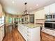 Spacious kitchen features a large island with seating, stainless steel appliances, and eat in dining at 2406 Tarleton Twins Ter, Charlotte, NC 28270