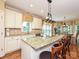 Bright kitchen features granite counters, an island with seating, and stainless steel appliances at 2406 Tarleton Twins Ter, Charlotte, NC 28270