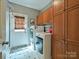 Efficient laundry room features modern appliances and ample cabinet storage for convenience at 2406 Tarleton Twins Ter, Charlotte, NC 28270