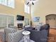 Living room with fireplace, vaulted ceiling, hardwood floors, and large windows at 2406 Tarleton Twins Ter, Charlotte, NC 28270