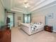 Spacious main bedroom featuring a tray ceiling, windows, and ensuite bathroom at 2406 Tarleton Twins Ter, Charlotte, NC 28270