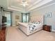 Spacious main bedroom featuring a tray ceiling, windows, and ensuite bathroom at 2406 Tarleton Twins Ter, Charlotte, NC 28270