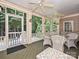 Relaxing screened-in porch with wicker furniture, offering a tranquil outdoor space at 2406 Tarleton Twins Ter, Charlotte, NC 28270