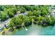 Aerial view of community featuring water access, dock, buildings, and lush, mature trees at 302 Northwest Dr, Davidson, NC 28036