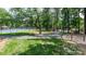 Community amenity area with tennis courts, walking path, and exercise bars under mature trees at 302 Northwest Dr, Davidson, NC 28036