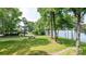 Lush green backyard offering serene views of the lake, ideal for relaxation and outdoor activities at 302 Northwest Dr, Davidson, NC 28036