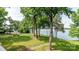 Beautiful green backyard with a walking path leading to the calm waters of the lake at 302 Northwest Dr, Davidson, NC 28036
