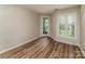 Bedroom featuring wood-look floors and view of the patio at 302 Northwest Dr, Davidson, NC 28036