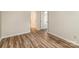 Neutral bedroom with wood plank flooring, and an open doorway to another room at 302 Northwest Dr, Davidson, NC 28036