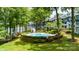 Landscaped community pool area with seating, surrounded by trees and near the lake at 302 Northwest Dr, Davidson, NC 28036