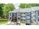 Well-maintained condo exterior with manicured landscaping, creating a welcoming curb appeal at 302 Northwest Dr, Davidson, NC 28036