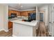 Features a kitchen with wood cabinets, breakfast bar, black appliances, and wood plank flooring at 302 Northwest Dr, Davidson, NC 28036