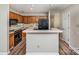 Well-lit kitchen features wood cabinets, modern black appliances, and plank flooring at 302 Northwest Dr, Davidson, NC 28036
