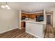 Bright kitchen features wood cabinets, black appliances, breakfast bar, and wood plank flooring at 302 Northwest Dr, Davidson, NC 28036
