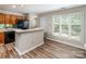 Bright living room features wood floors and is open to the kitchen, making it ideal for entertaining at 302 Northwest Dr, Davidson, NC 28036