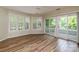 Bright living room featuring wood floors and sliding doors to the outdoor deck, providing water views at 302 Northwest Dr, Davidson, NC 28036