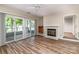 Bright living room featuring wood floors, fireplace, wet bar, and sliding doors to the outdoor deck at 302 Northwest Dr, Davidson, NC 28036