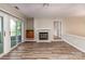 Bright living room featuring wood floors, fireplace, wet bar, and sliding doors to the outdoor deck at 302 Northwest Dr, Davidson, NC 28036
