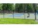 Outdoor pickleball courts with a black fence and green surroundings perfect for recreational activities at 302 Northwest Dr, Davidson, NC 28036