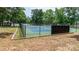 Fenced tennis courts with a gazebo, offering a recreational amenity with a serene, wooded backdrop at 302 Northwest Dr, Davidson, NC 28036