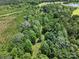 Lush greenery surrounds a sprawling countryside property with a large pond nearby at 4636 Brown Creek Church Rd, Wadesboro, NC 28170