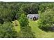 Aerial view of a charming home nestled among lush trees, providing a private and serene setting at 4636 Brown Creek Church Rd, Wadesboro, NC 28170