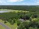 Aerial view of a home surrounded by lush forest and a nearby lake, offering a serene and natural retreat at 4636 Brown Creek Church Rd, Wadesboro, NC 28170