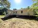 A house's backyard with a white porch and green grass at 4636 Brown Creek Church Rd, Wadesboro, NC 28170