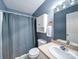 A full bathroom with a shower-tub combo, vanity, and white cabinet at 4636 Brown Creek Church Rd, Wadesboro, NC 28170