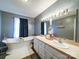 Bathroom with soaking tub, vanity with double sinks, and stylish fixtures at 4636 Brown Creek Church Rd, Wadesboro, NC 28170