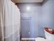 A bathroom with a shower-tub combo and a toilet with gray walls at 4636 Brown Creek Church Rd, Wadesboro, NC 28170