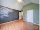 A bedroom with hardwood floors, vaulted ceiling, and a unique wall painting at 4636 Brown Creek Church Rd, Wadesboro, NC 28170