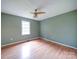 Bedroom with hardwood floors, ceiling fan, and natural light from a window at 4636 Brown Creek Church Rd, Wadesboro, NC 28170