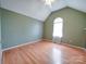 Spacious bedroom with hardwood floors, a vaulted ceiling, and a bright window at 4636 Brown Creek Church Rd, Wadesboro, NC 28170